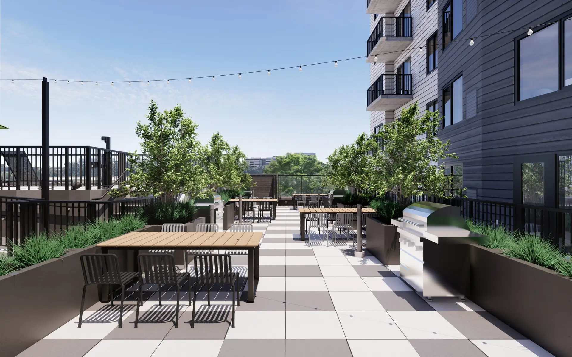 Outdoor terrace with tables, chairs, and lush greenery.