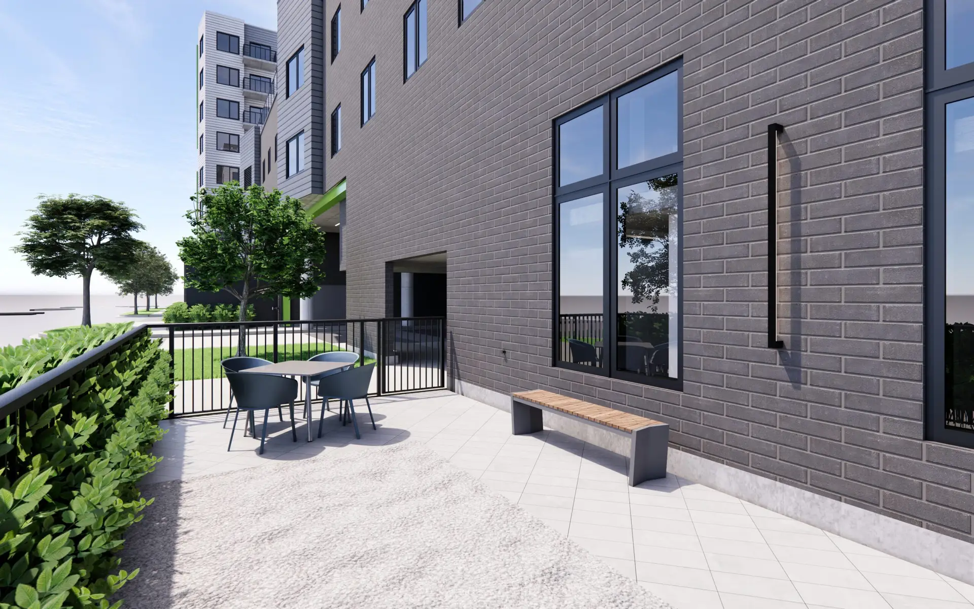 Outdoor seating area with a bench and a table, adjacent to the building.