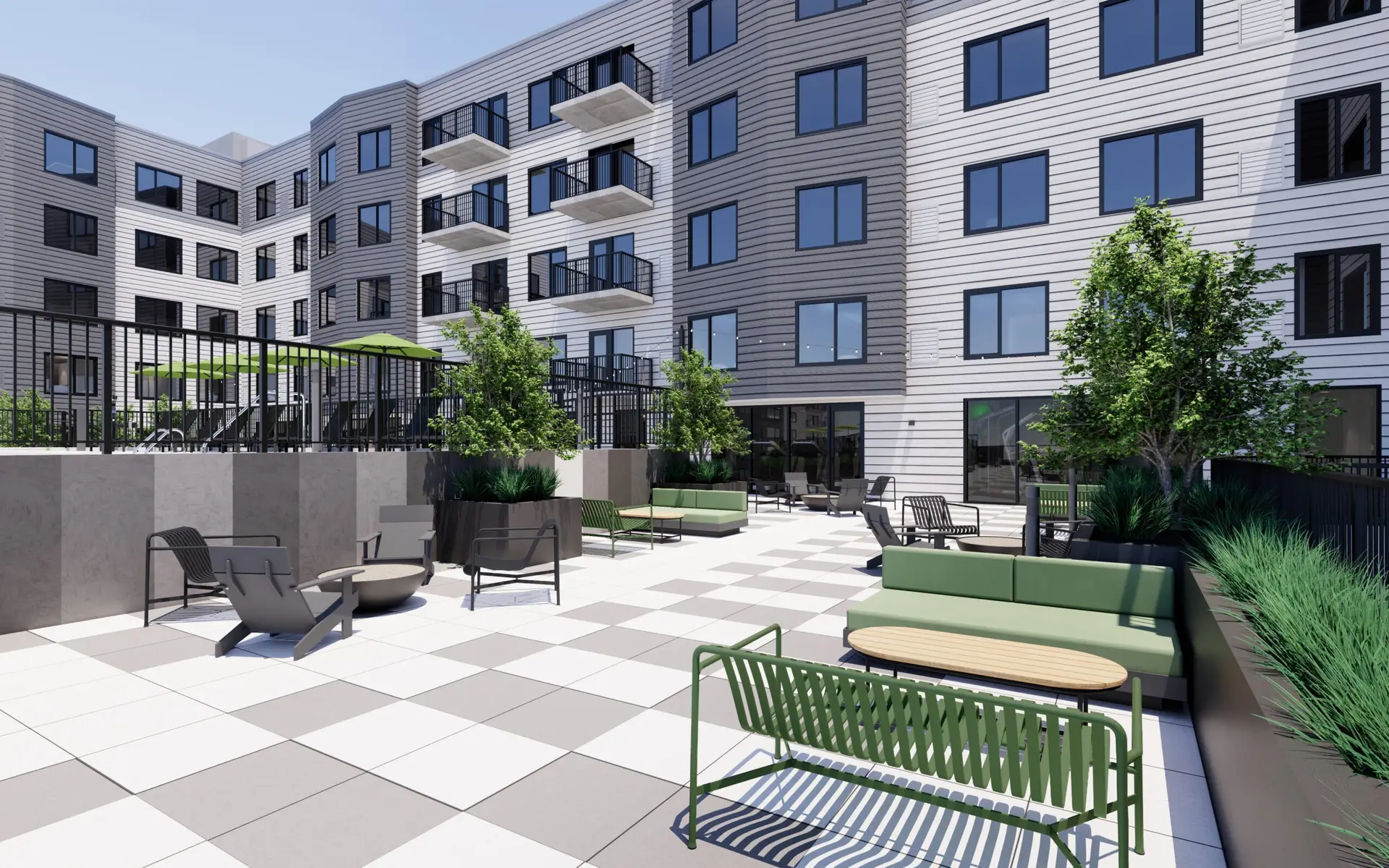 Large outdoor terrace with seating and greenery, part of Arlington Heights apartment complex.