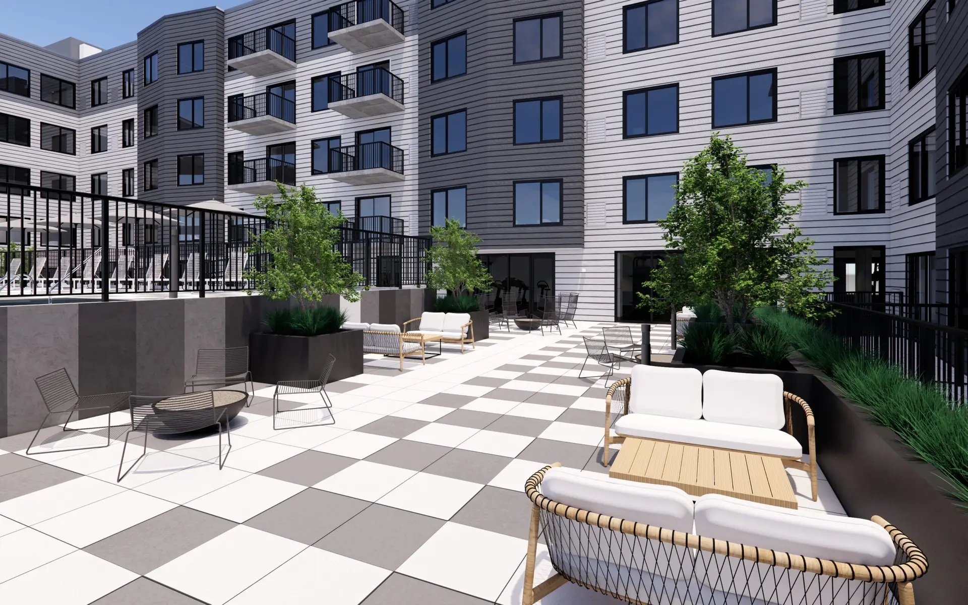 Terrace seating area with modern furniture and greenery.